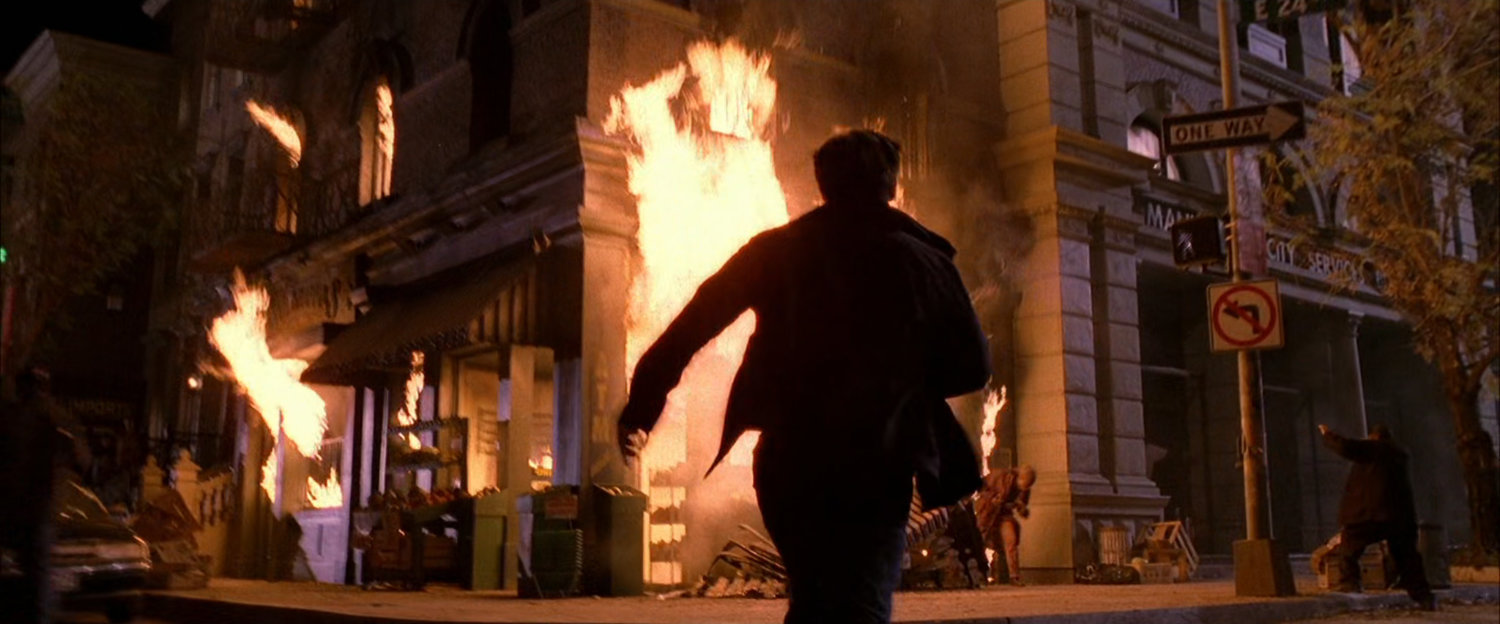 Peter Parker runs into burning apartment building.