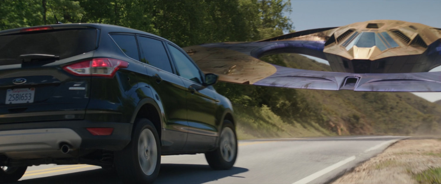 A Ford SUV braking to avoid hitting a Sakaaran Class-Eight courier craft.