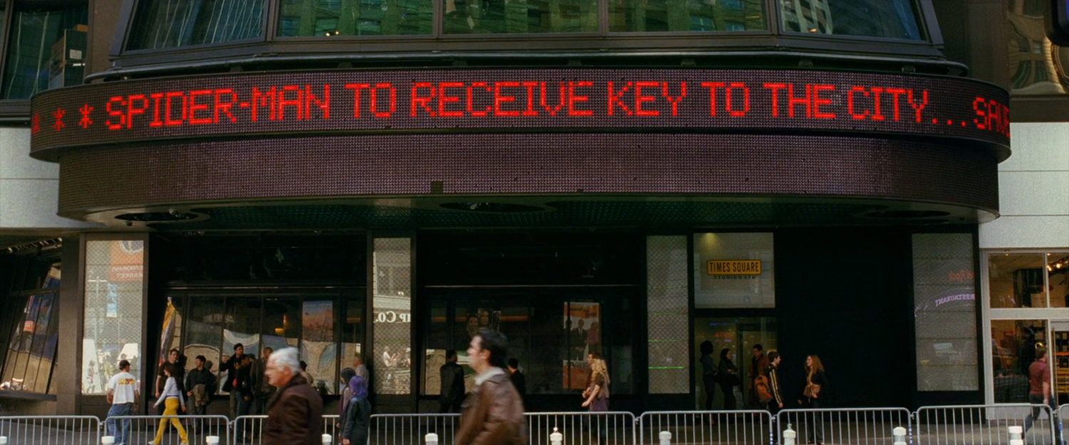 Text ticker in Times Square, text: Spider-Man to receive key to the city.