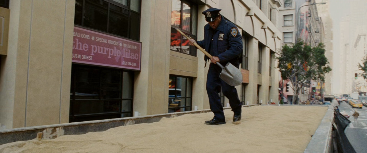 Police officer investigates truck filled with sand.