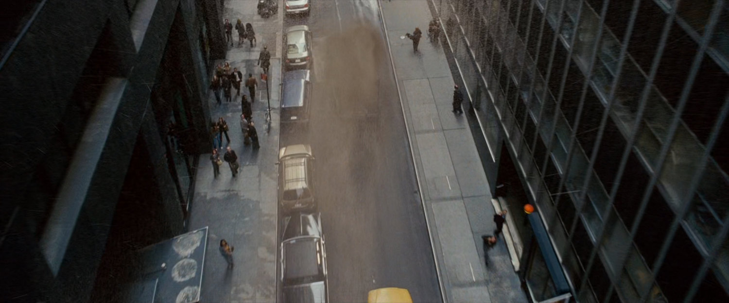 A sandstorm blowing down a narrow street.
