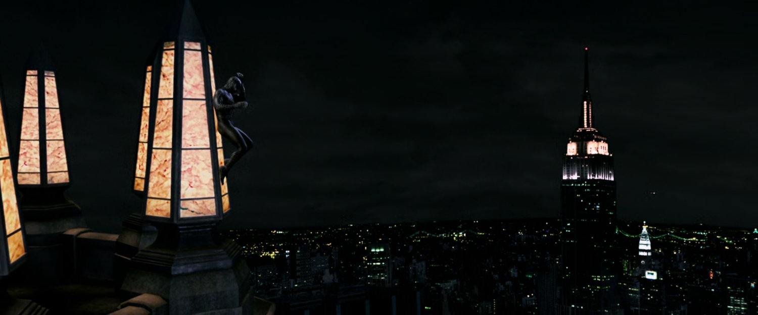 Spider-Man on building spire at night.