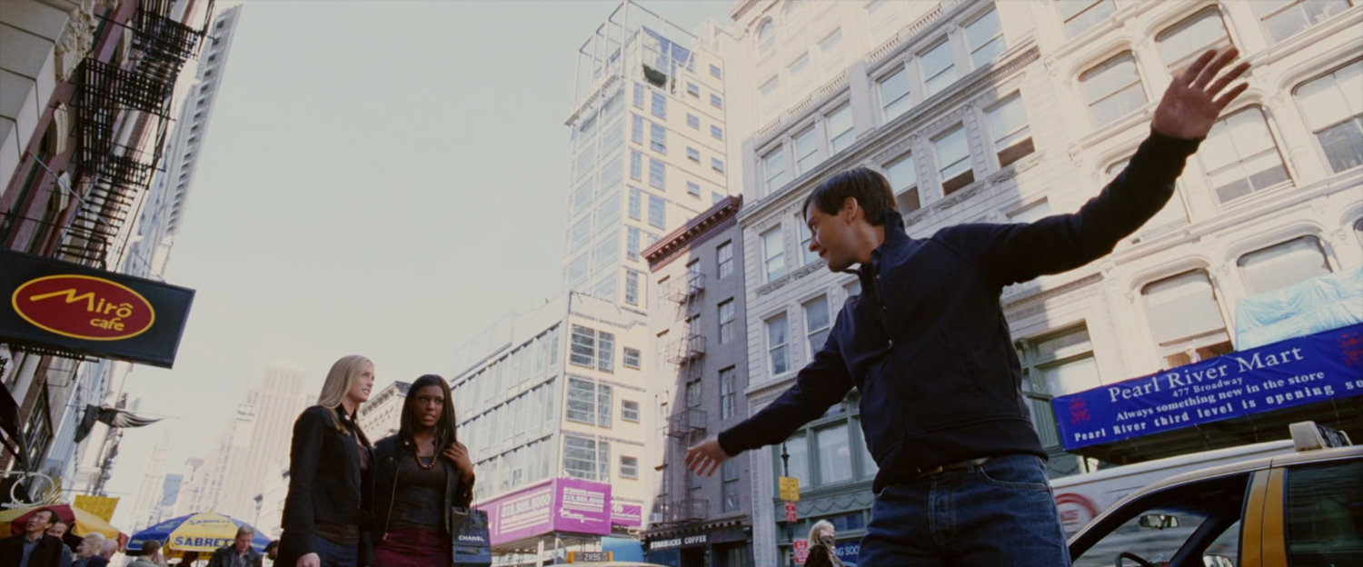 Peter Parker dancing on sidewalk.