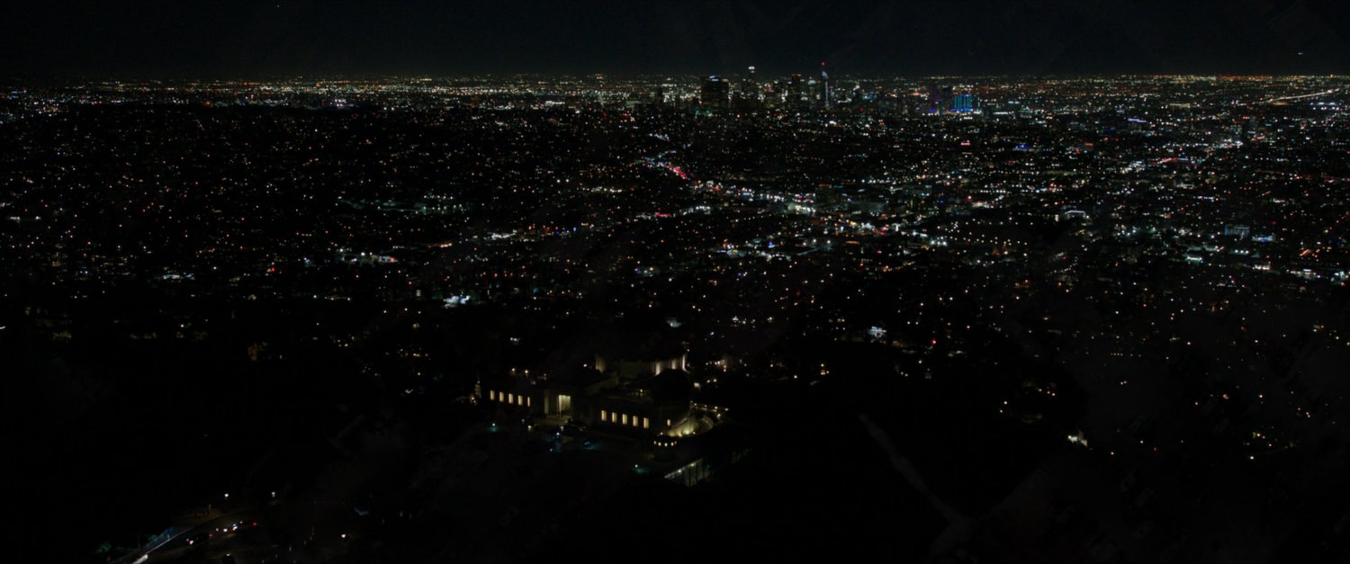Night time aerial shot of downtown Los Angeles with the Griffith Observatory.