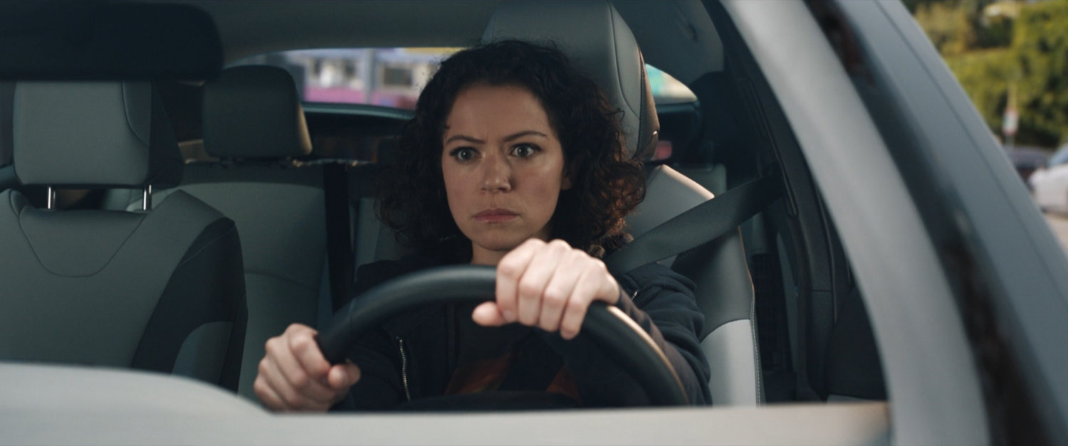 Jen Walters sitting behind the wheel of her car.