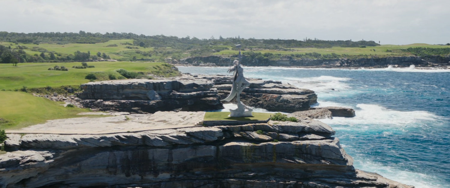 The coastline of New Asgard, with a statue of Mighty Thor.