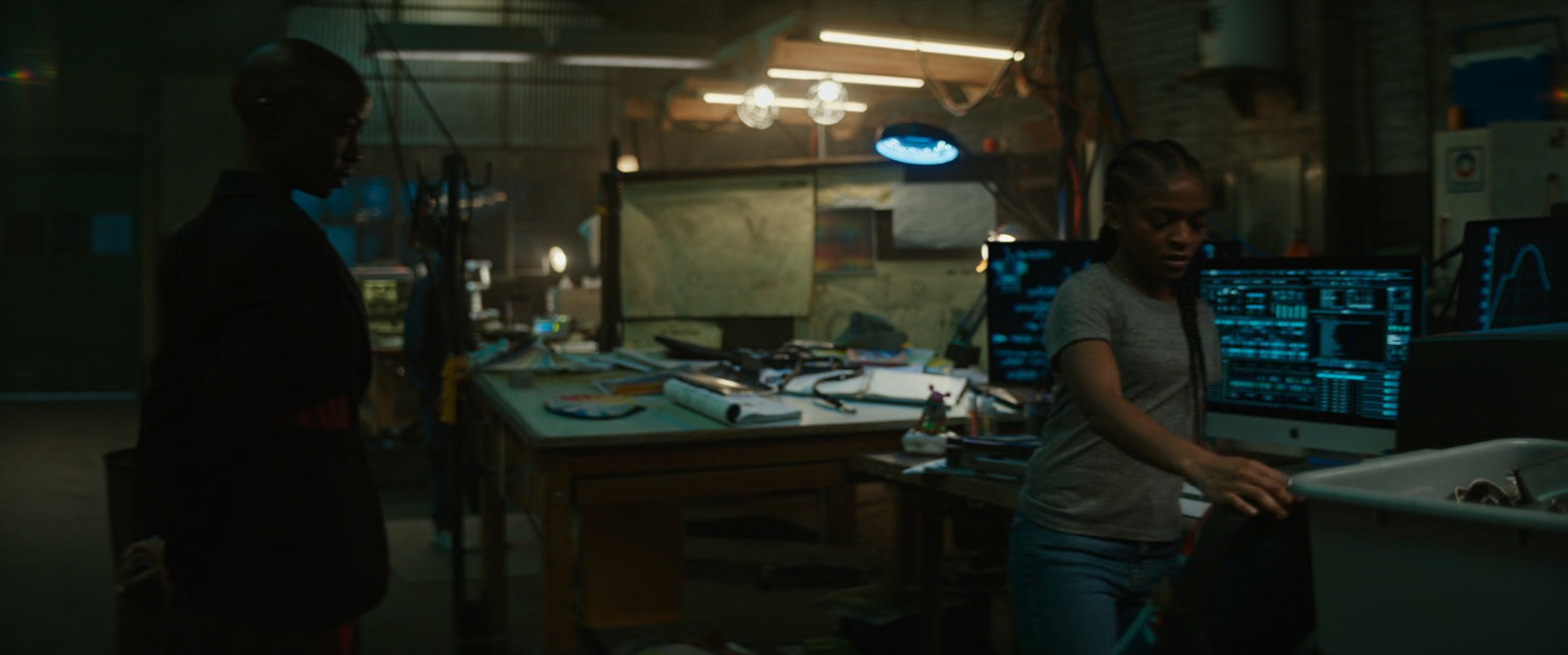 Okoye and Riri in a Boston warehouse at night.