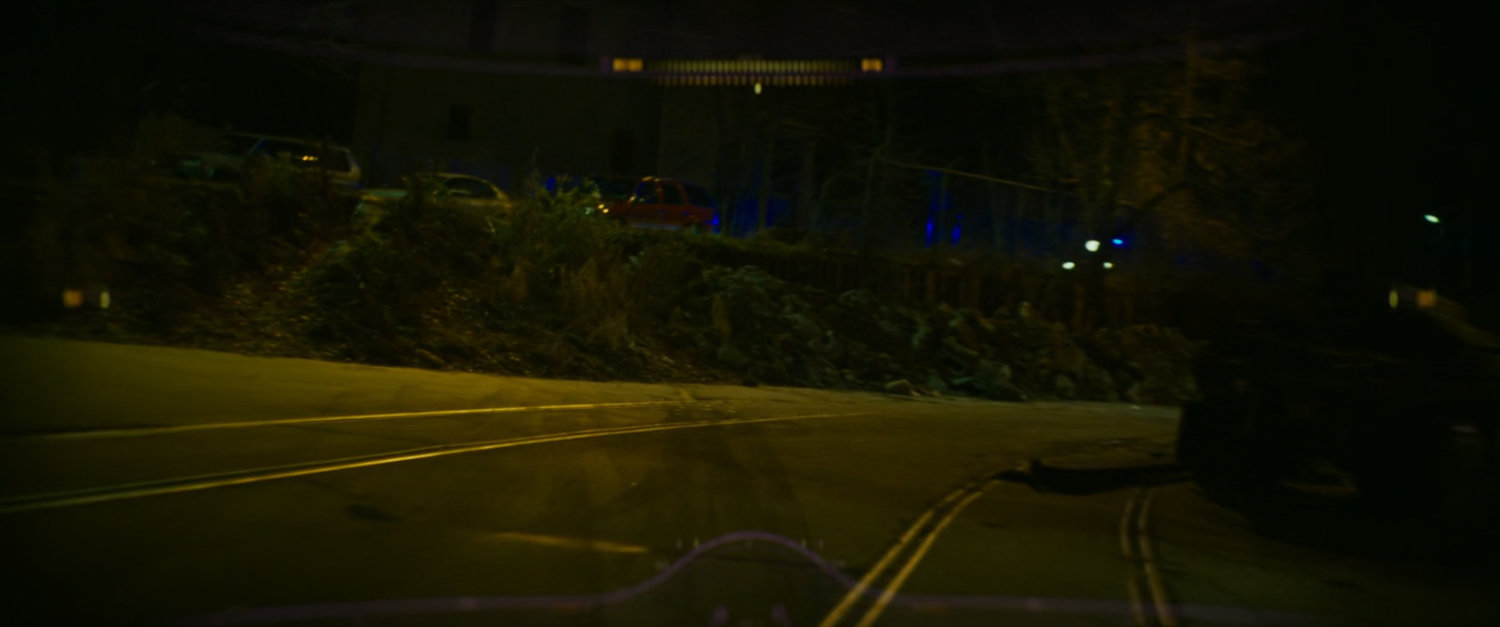Road outside Boston warehouse at night.