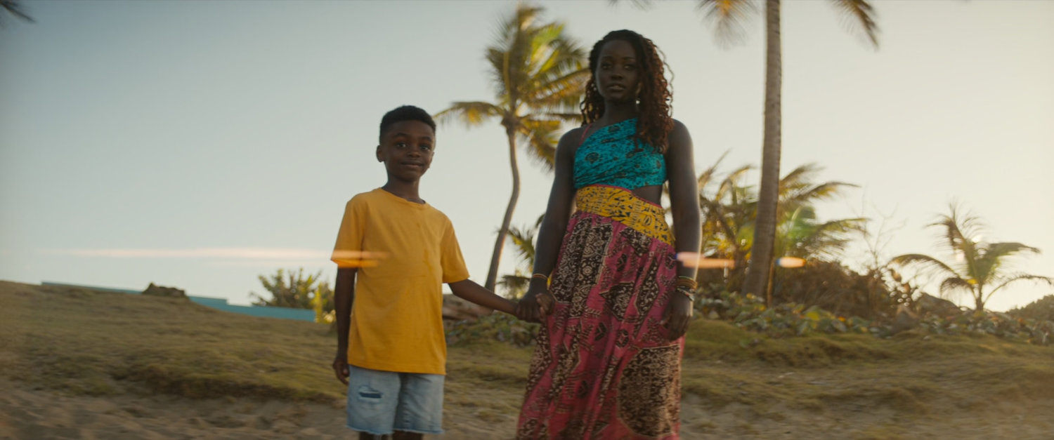 Nakia and a young boy, Toussaint, on a beach.