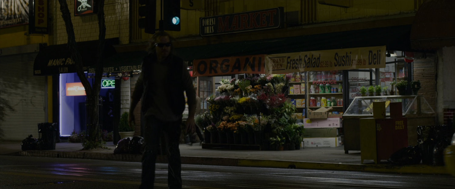 Exterior of the Forest Hills Market at night.