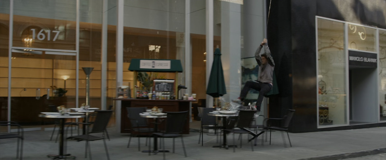 Peter Parker swings by a store and crashes into outdoor table and chairs.