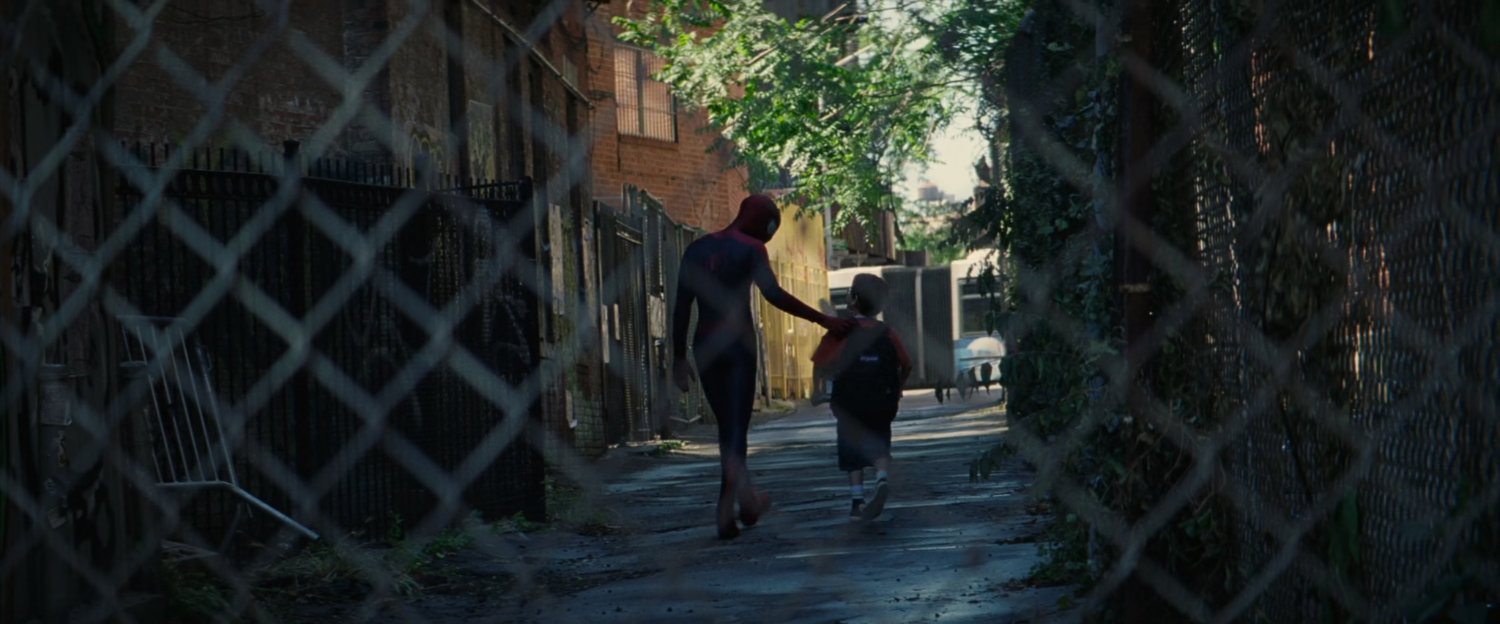 Spider-Man and young boy walk through alley.