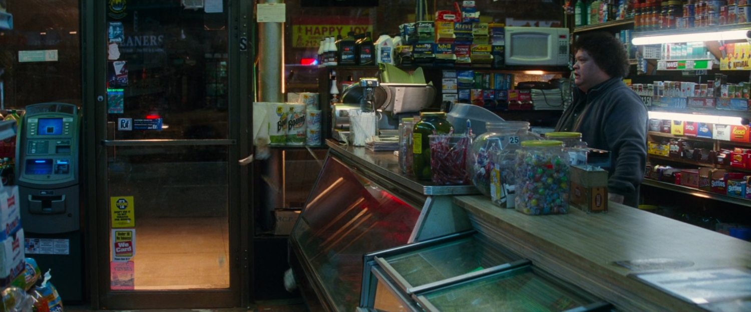 Clerk behind counter in bodega.