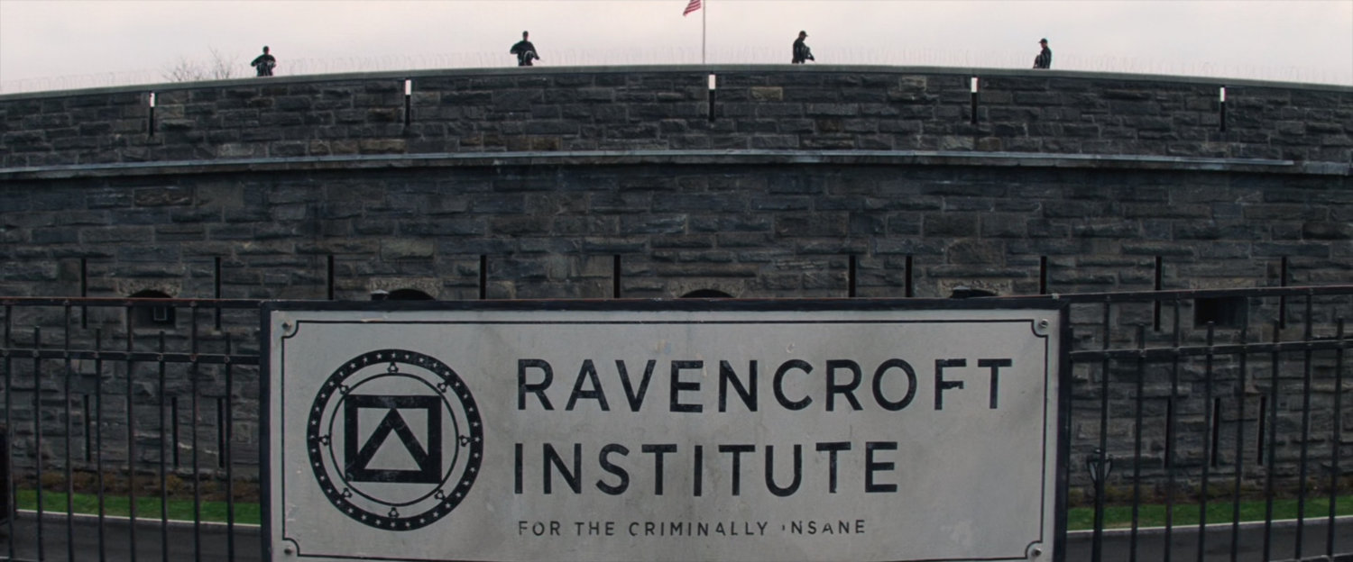 Wall outside Ravencroft Institute with sign.