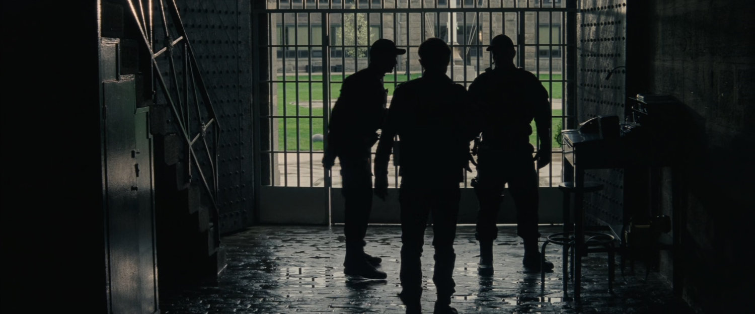 Silhouetted men inside Ravencroft Institute.