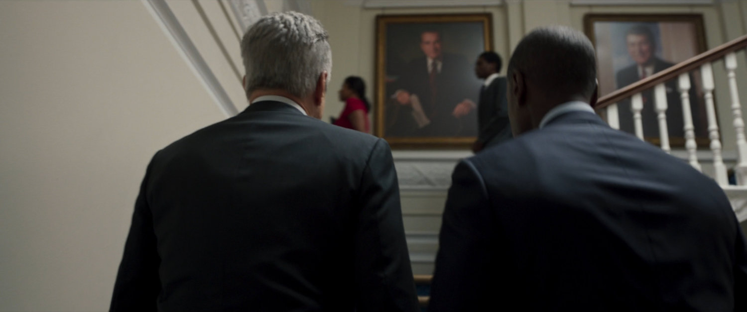 James Rhodes and President Ritson ascend stairs in the White House.