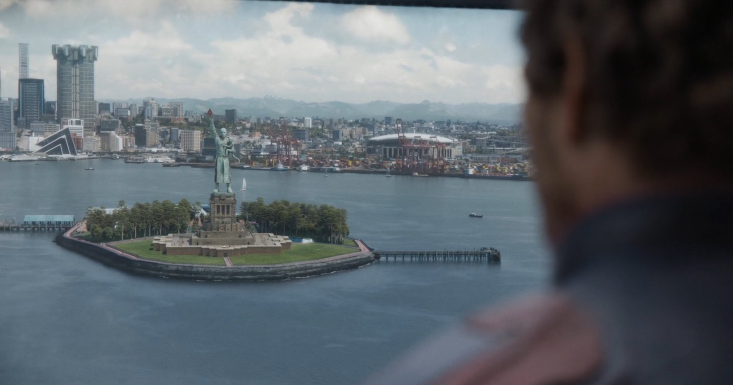 Aerial view of High Evolutionary statue on small island in Counter-Earth harbor.