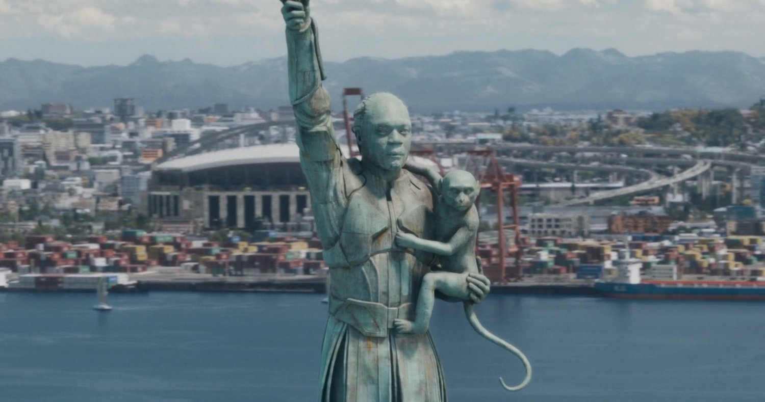 Close-up of High Evolutionary statue on small island in Counter-Earth harbor.