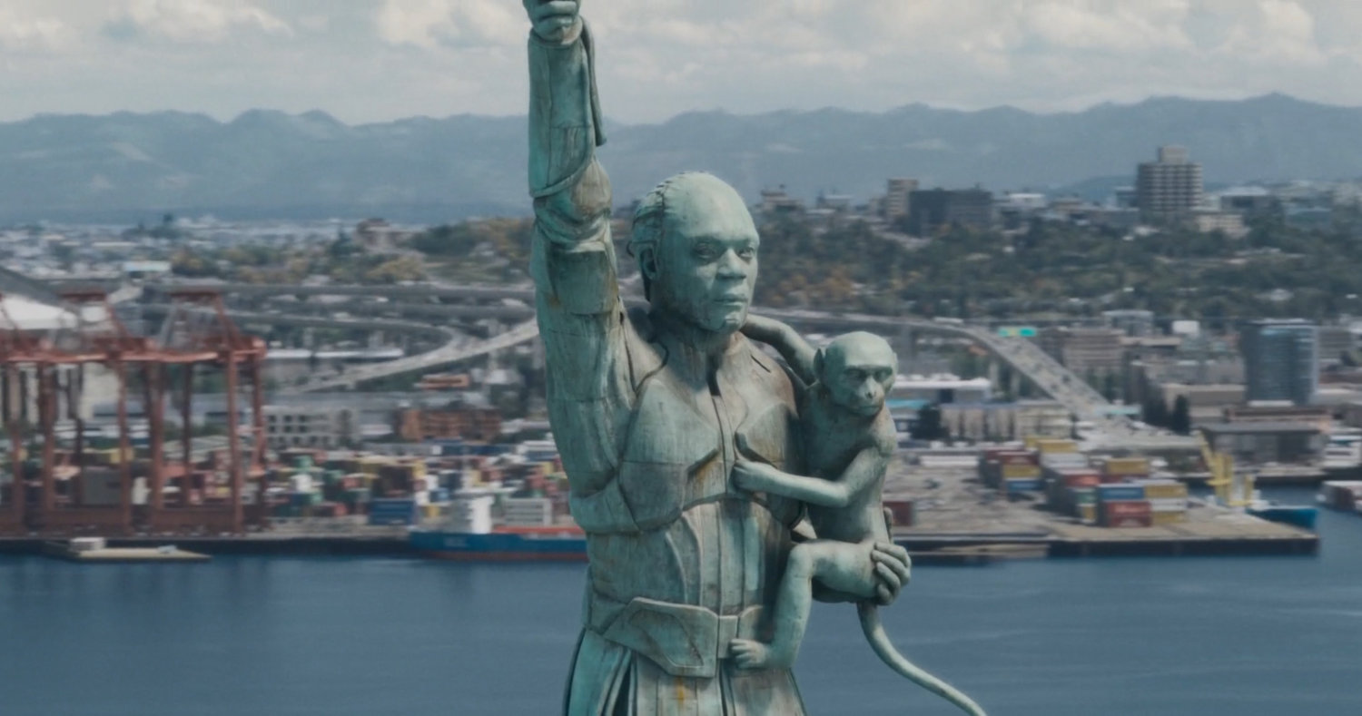 Close-up of High Evolutionary statue on small island in Counter-Earth harbor.