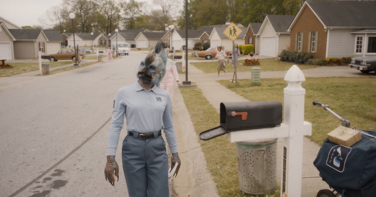 Postal worker humanimal on suburban street.