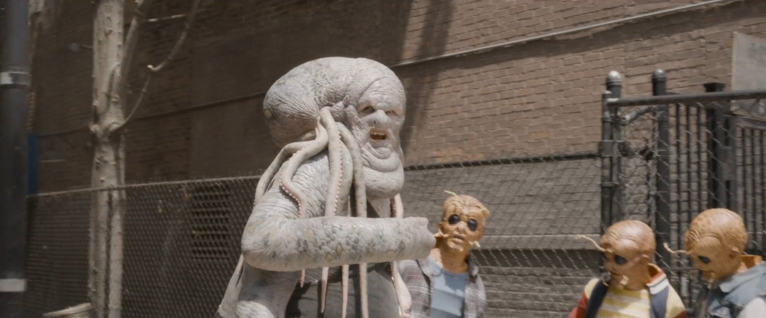 A octopus humanimal sells drugs to young humanimals in an alley.