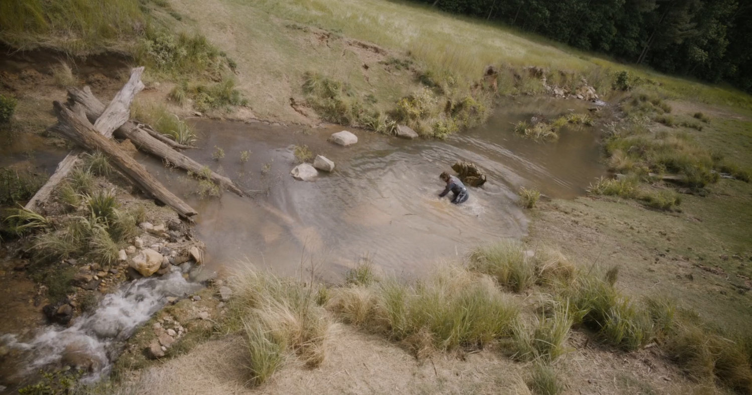 Star-Lord and Groot in small stream in Counter-Earth field.