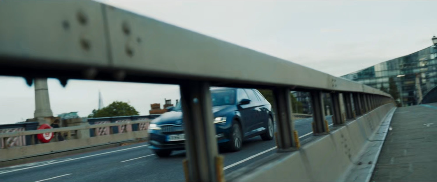 A car drives over a London bridge.
