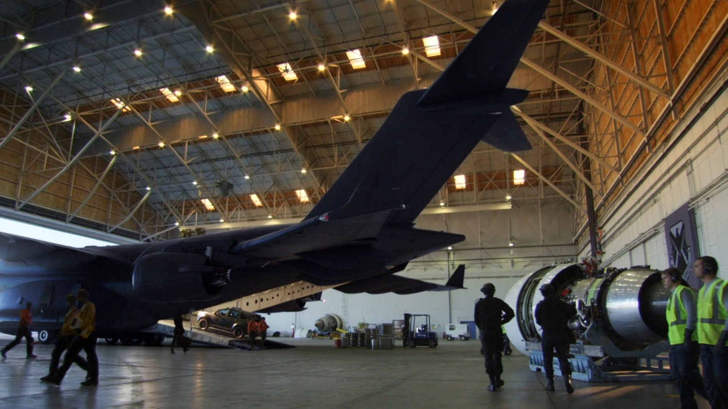 SHIELD vehicles and "The Bus" in airfield hangar.