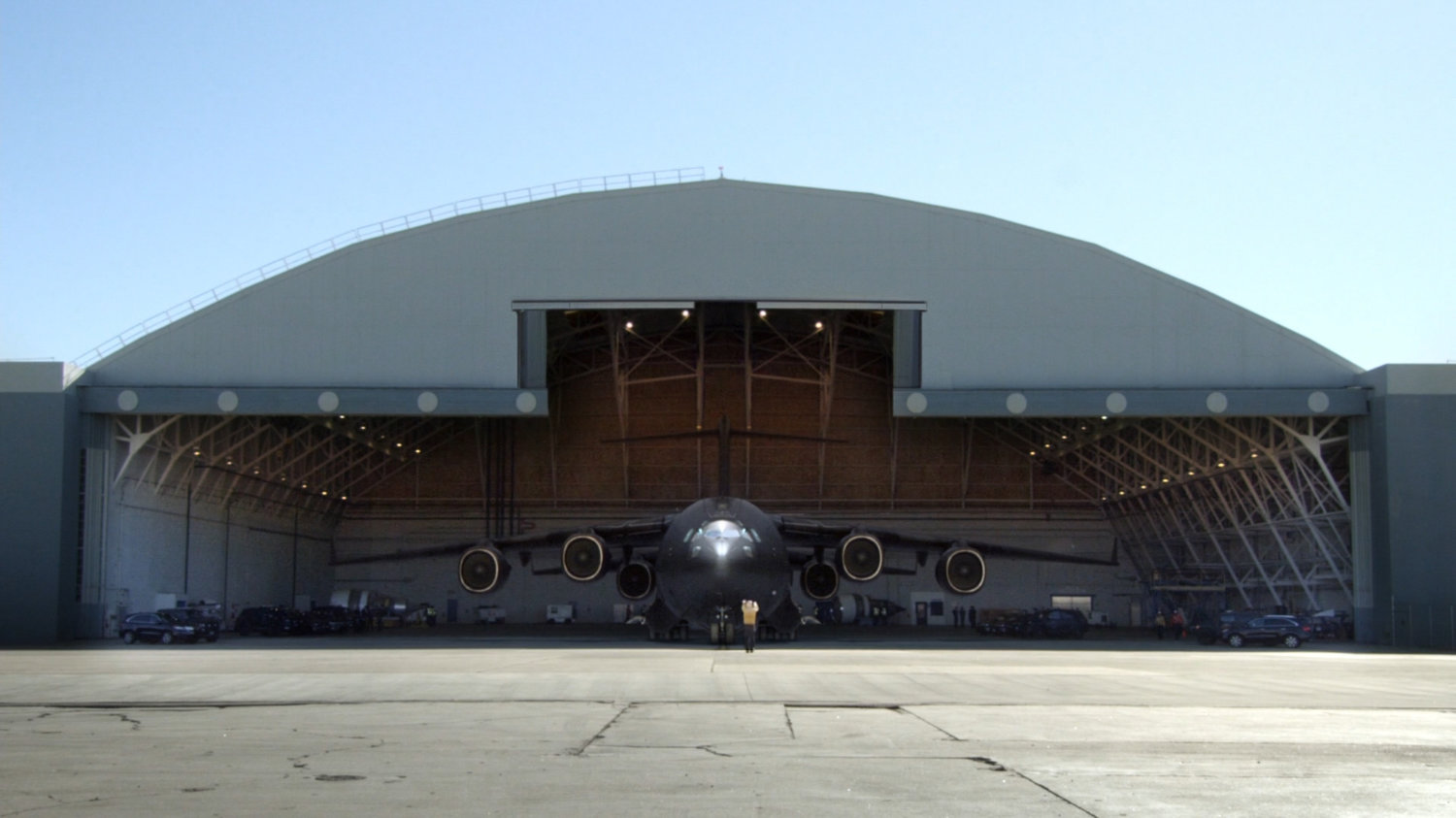 The Bus pulling out of airport hangar.