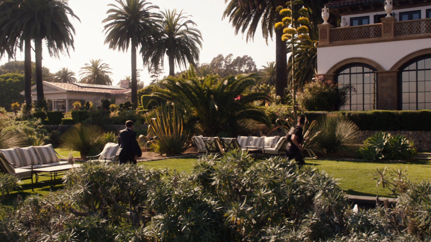 Coulson and Ward walk across Ian Quinn's lawn on his estate.