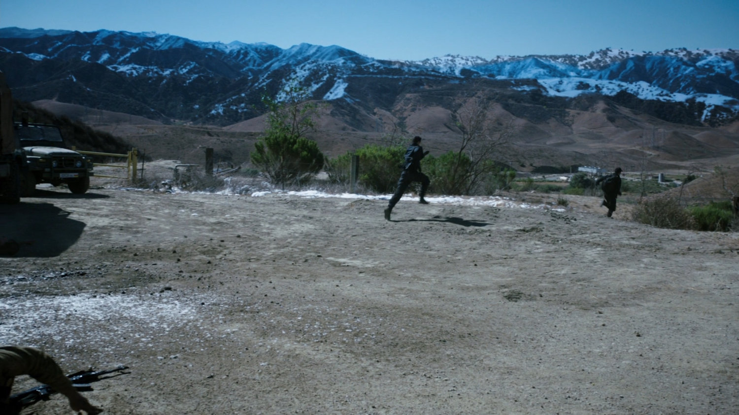 Ward and Fitz run out of a a Caucasus Mountain open area.