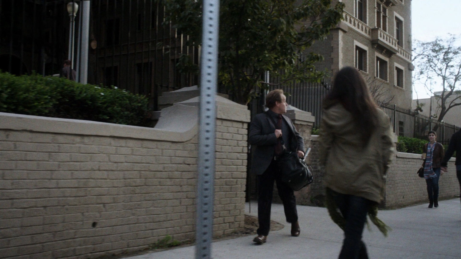 Professor Randolph on the sidewalk outside his university.