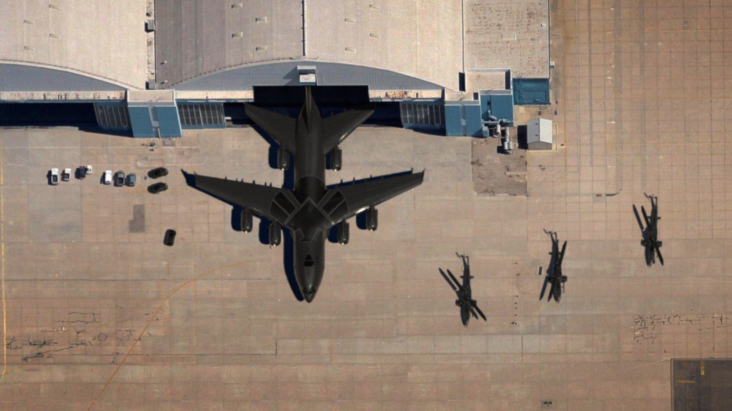 Aerial of The Bus exiting an airport hangar.