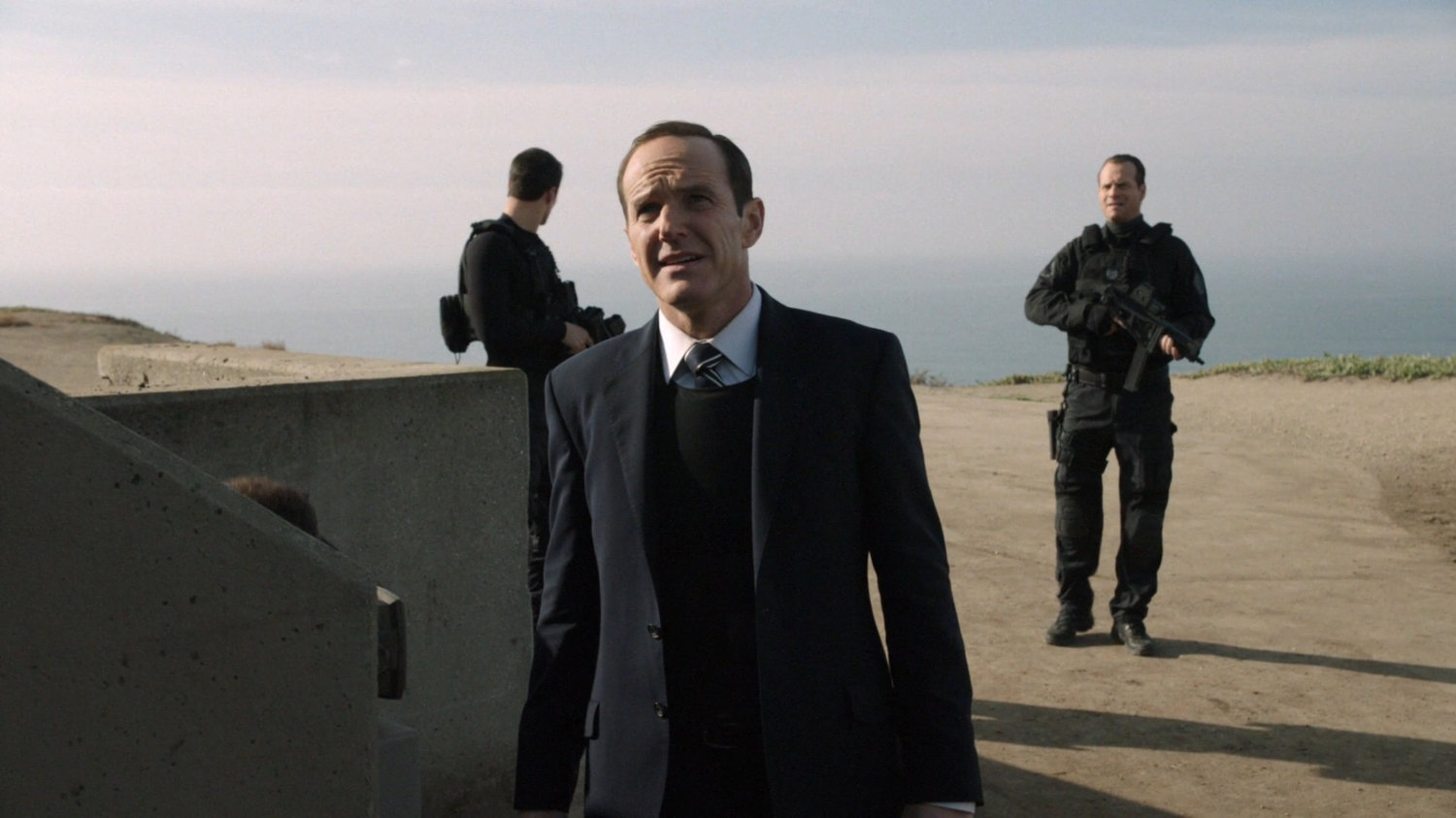 Agents Coulson, Ward, and Garret on the bluff containing the Guest House.