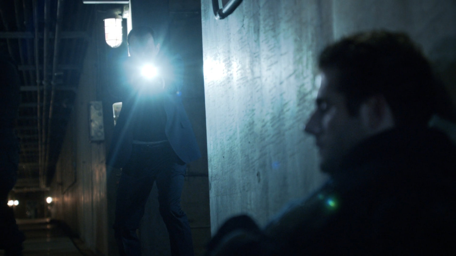 Coulson shines flashlight on downGuest House guard.