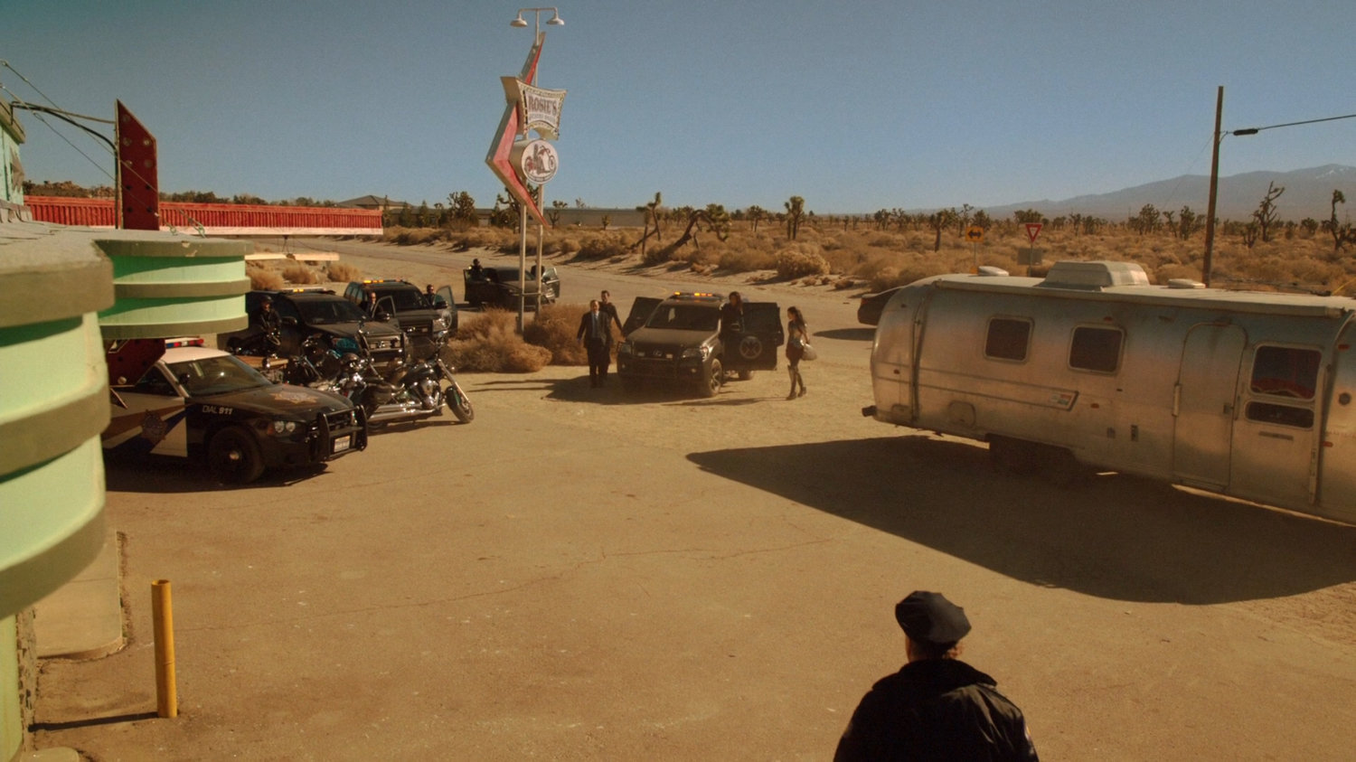 SHIELD SUVs pull up outside Rosie's Desert Oasis.