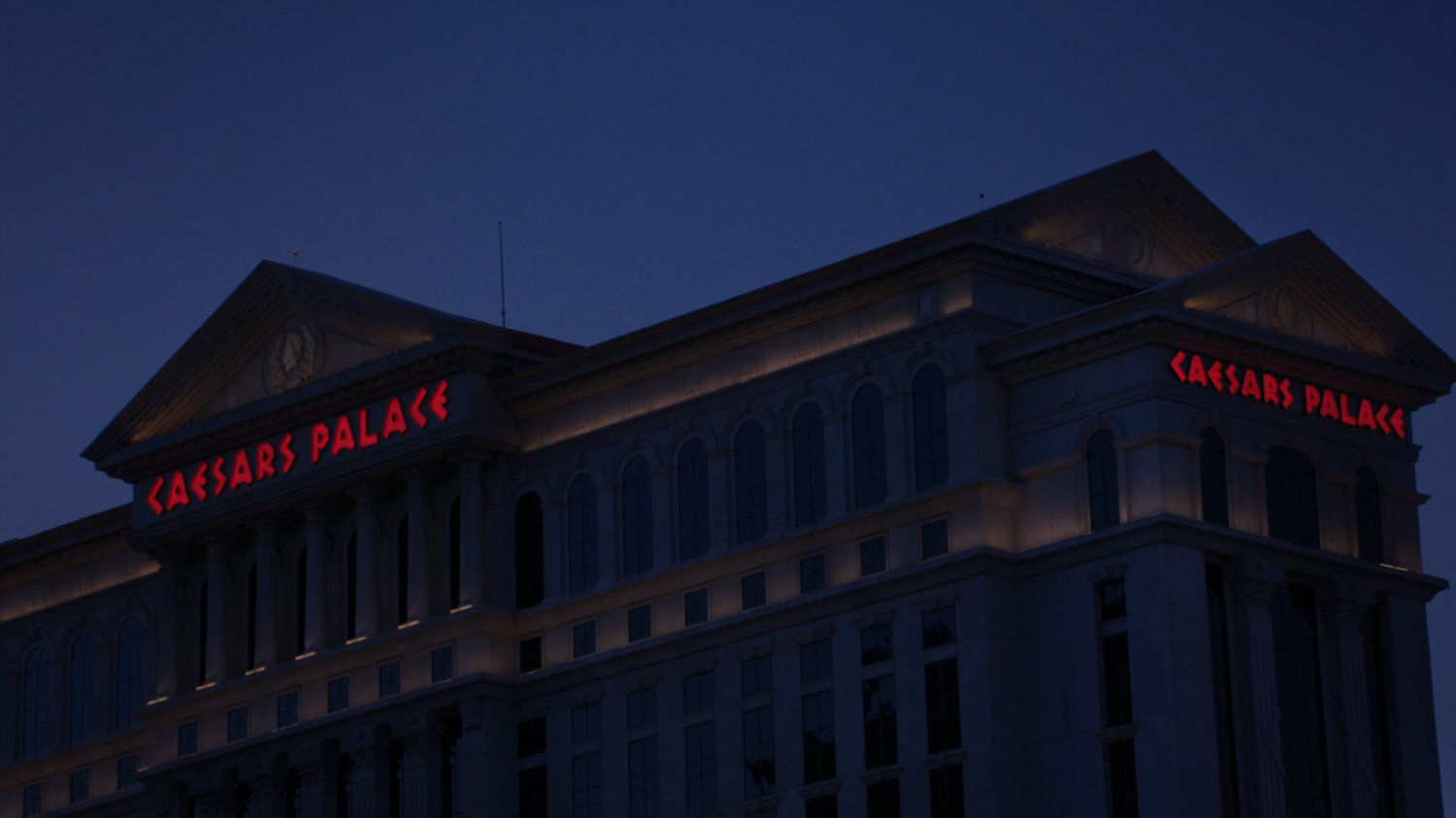 Nighttime exterior of Caesars Palace in Las Vegas.