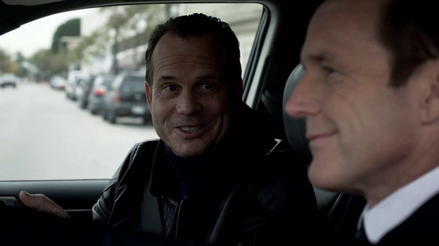 Coulson and Garrett in a vehicle driving on an Indiana street.