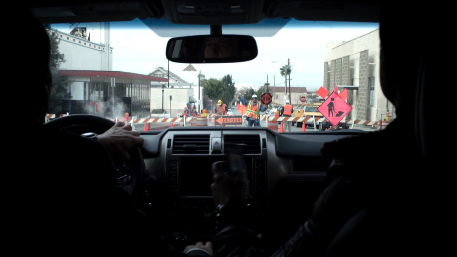POV from inside vehicle as it approaches road construction.