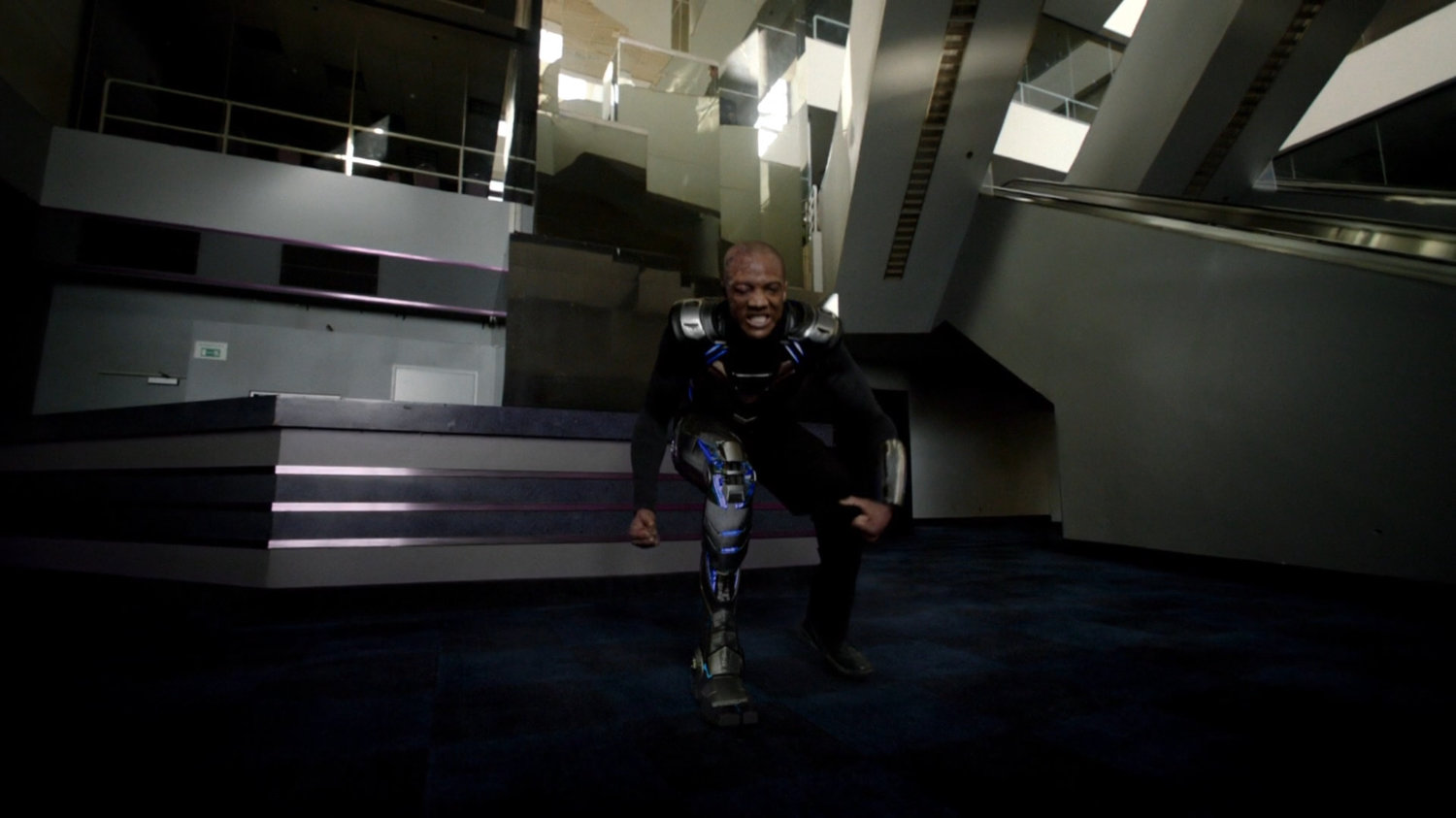 Deathlok does a super hero landing inside an abandoned racetrack.