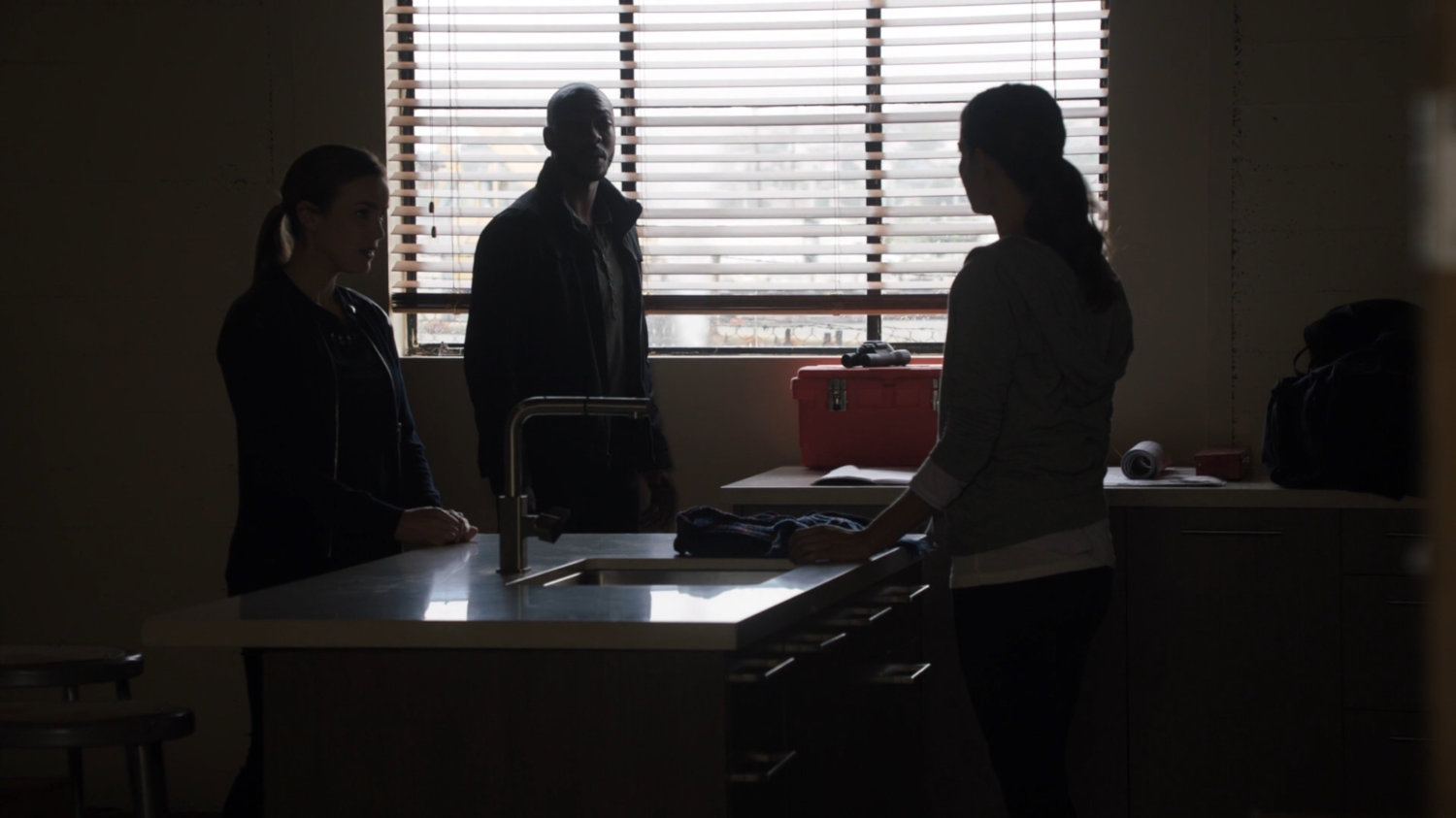 Simmons and Tripp talk with Audrey Nathan inside a Portland apartment building.