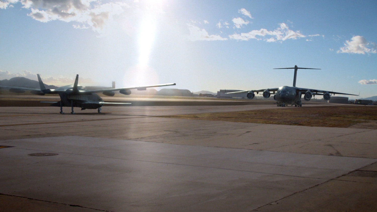 A smaller plane pointing towards The Bus on an airport runway.