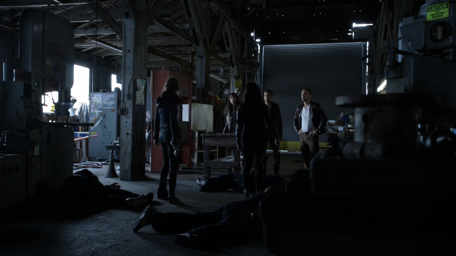 SHIELD agents standing in old warehouse.