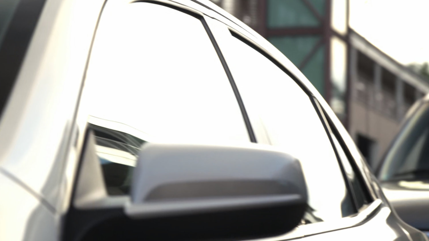 Raina's car with background building.