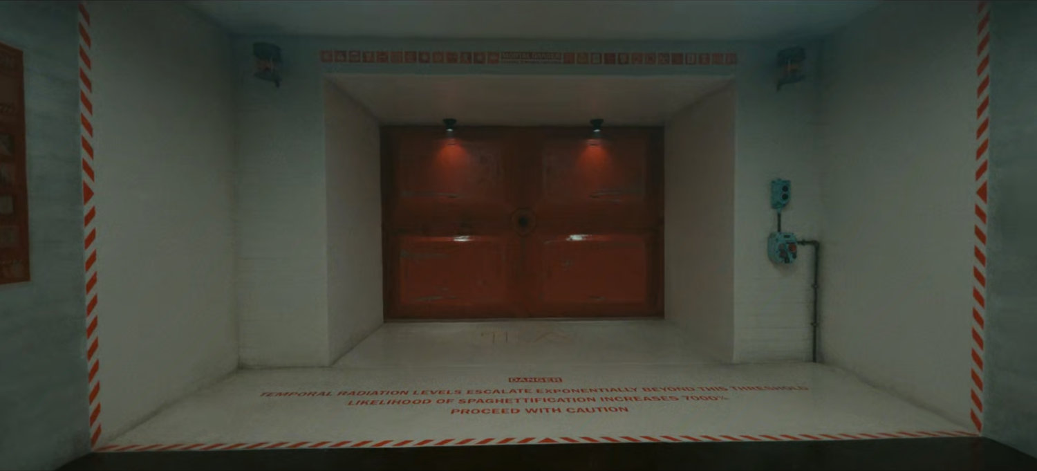 The doorway to the TVA Temporal Loom. Text: DANGER: Temporal Radiation Levels Escalate Exponentially Beyond This Threshold. Likelihood of Spaghettification Increases 7000%. Proceed With Caution.