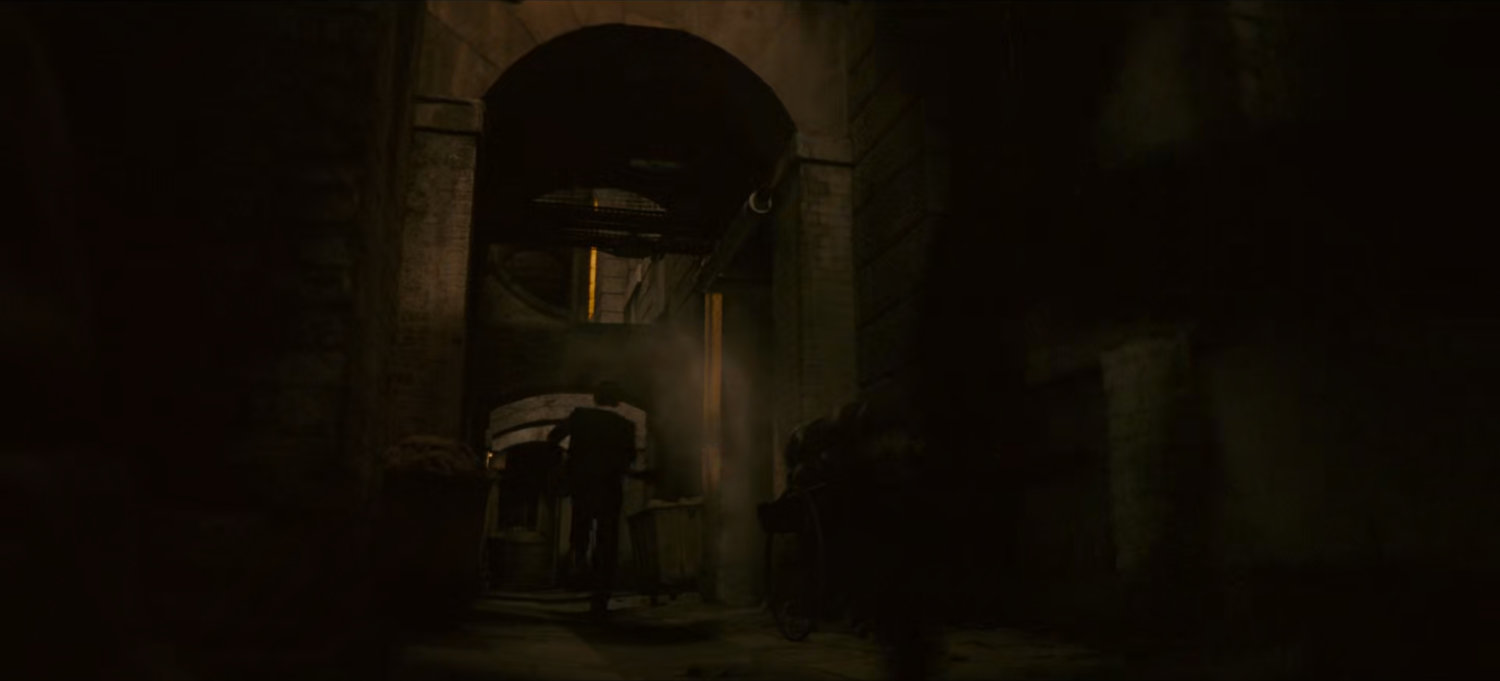 Loki chases Brad through dark alley.