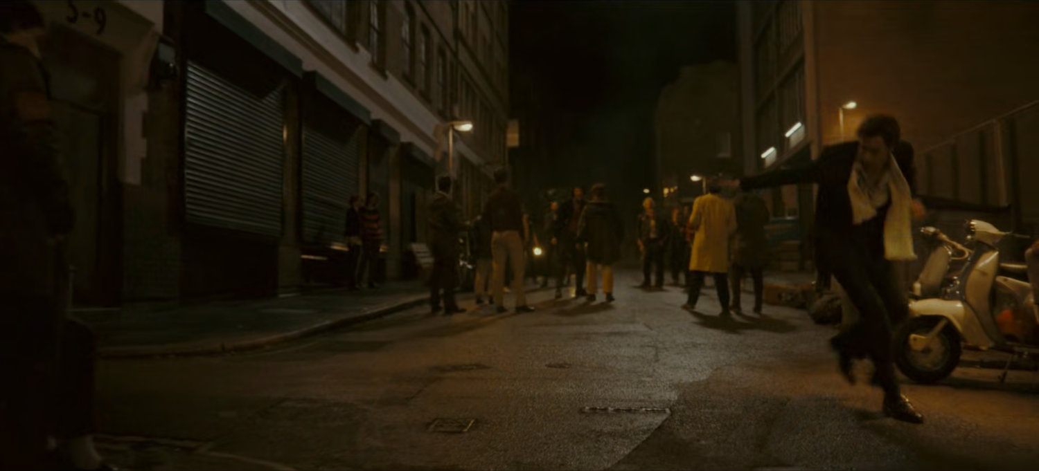 Brad on a dark London street.
