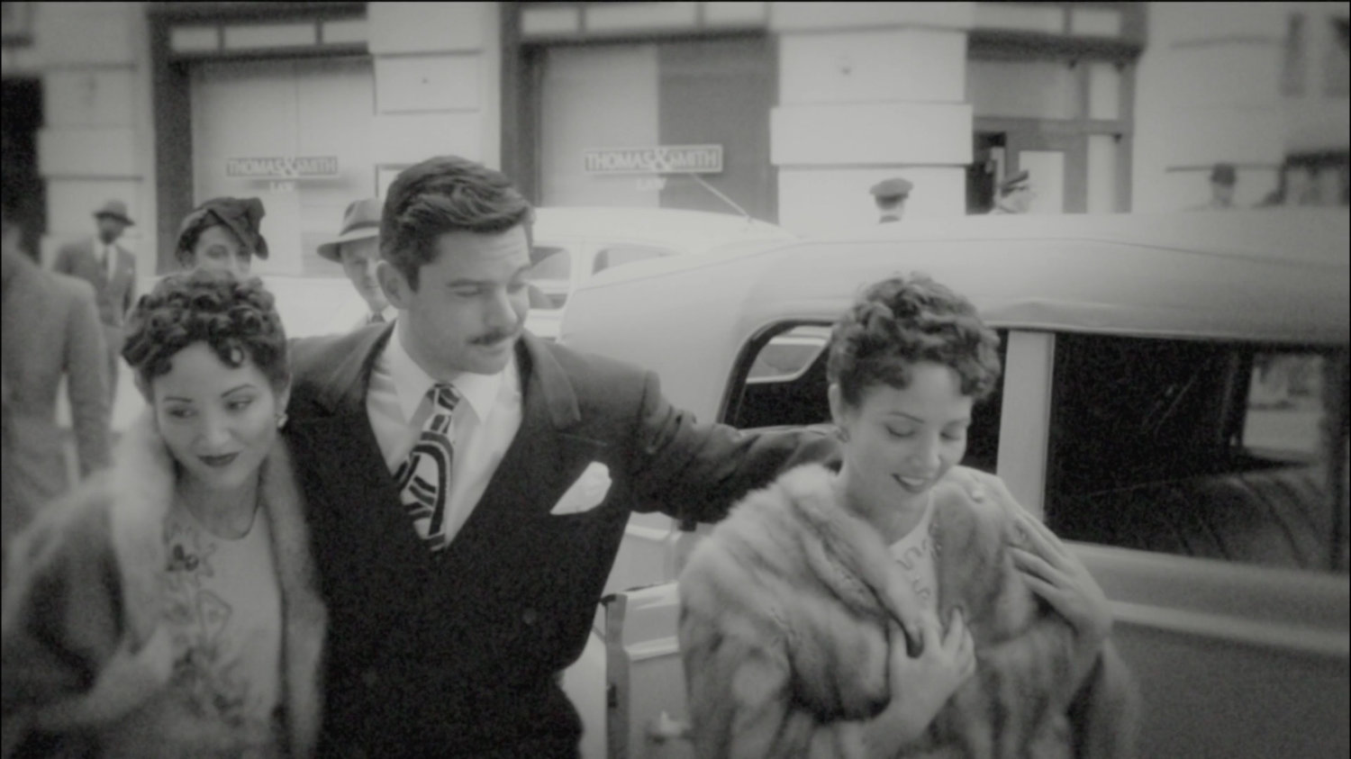 Howard Stark and two women across from Law Offices.