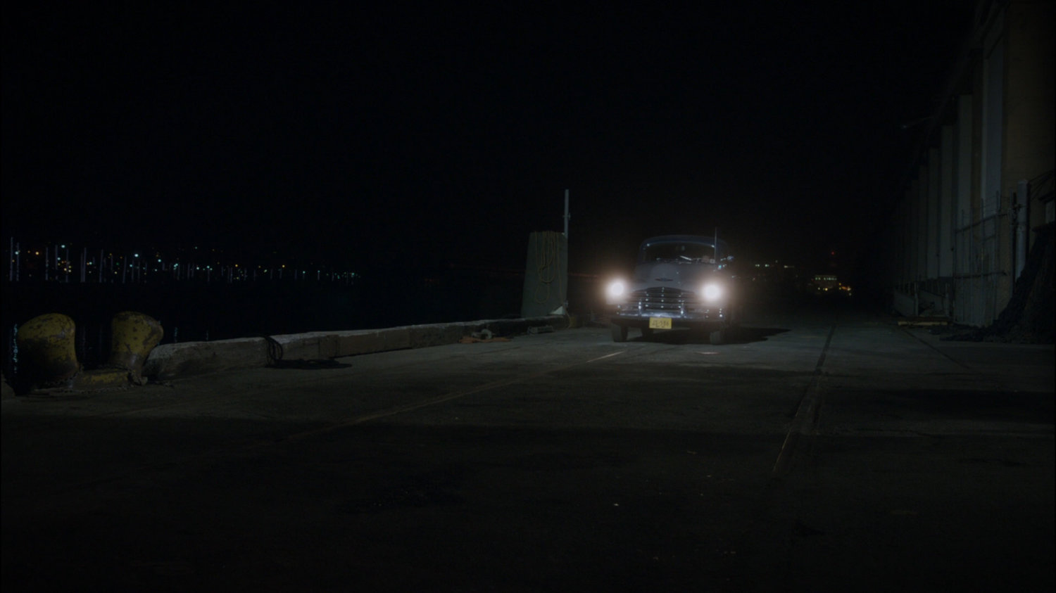 Car pulling up along wharf.