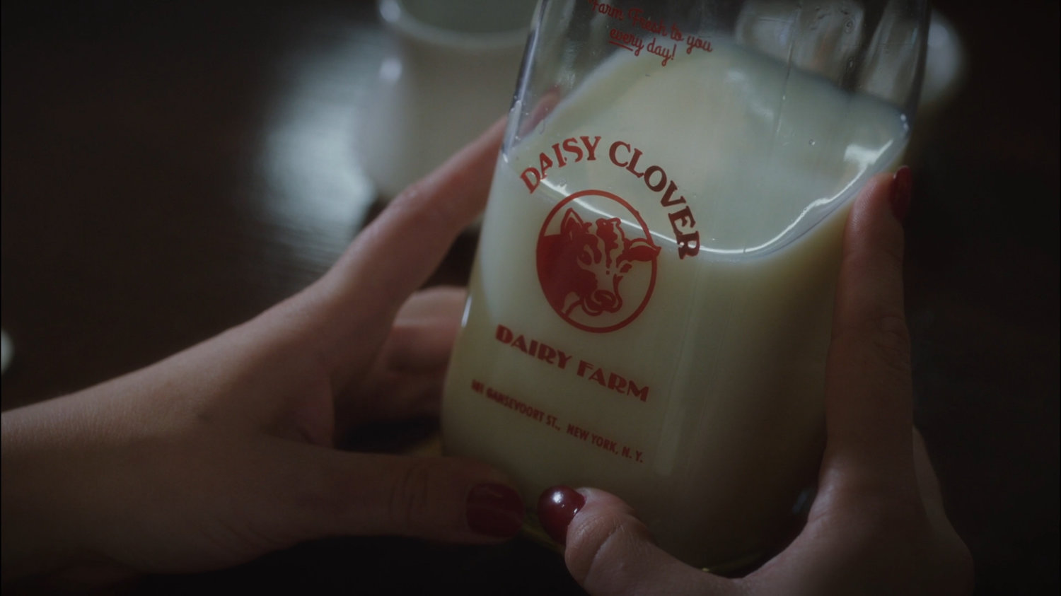 Closeup Daisy Clover milk bottle.